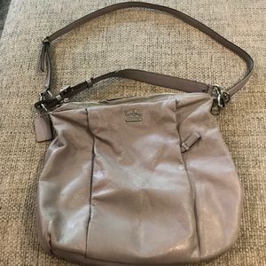 Light gray leather Coach bag with green lining.